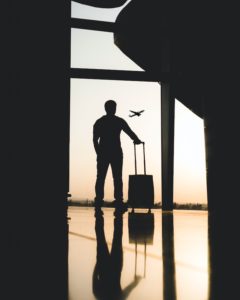 Person Standing with Suitcase in Airport