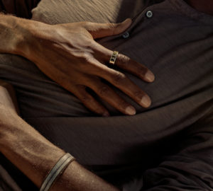 Man sleeping with hands on chest wearing an Oura Ring