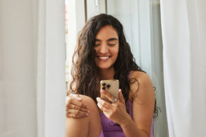 Oura and Natural Cycles: Woman Checking Fertility App on Her Smartphone