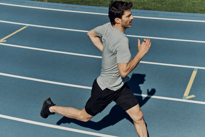 Man Running on Track Wearing Oura Ring