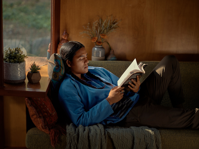 Man Reading on Couch Wearing Oura Ring