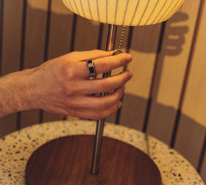 Man Wearing Oura Ring and Turning off the Light