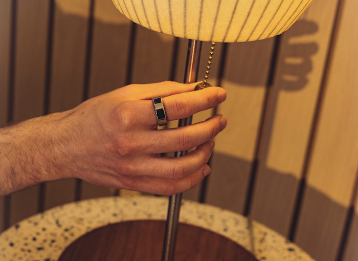 Man Wearing Oura Ring and Turning off the Light
