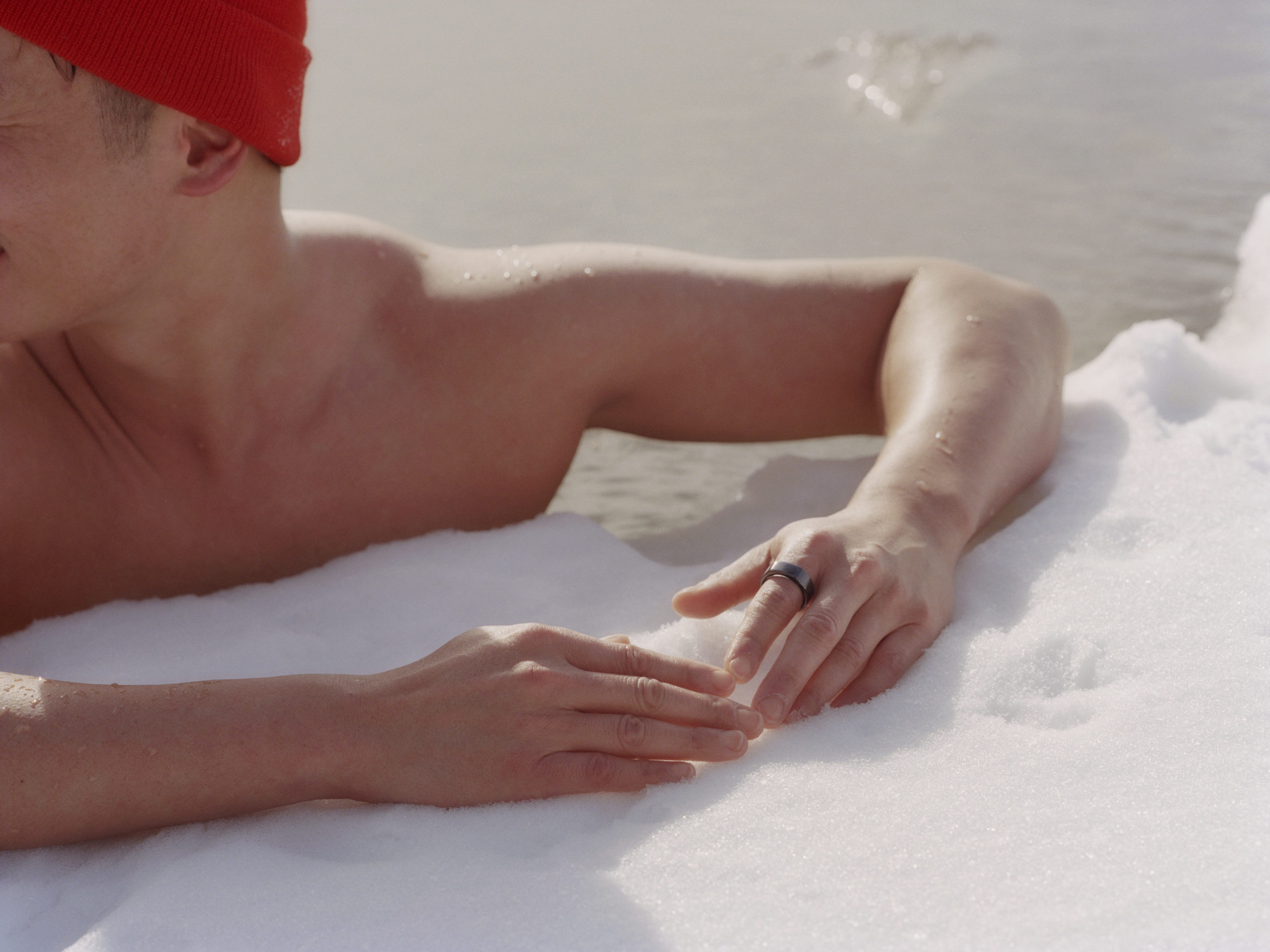 Man ice swimming wearing Oura Ring