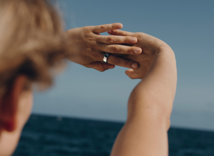 Woman wearing Oura Ring with hands outstretched