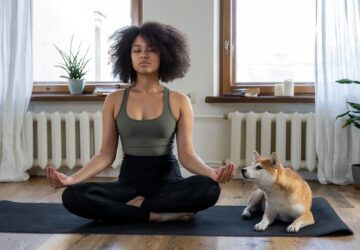 Guided Meditations By Oura Ring: woman meditation on yoga mat with dog