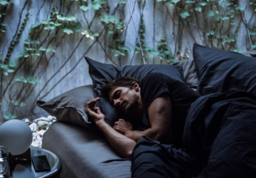 Man sleeping in dark bedroom | Oura Ring
