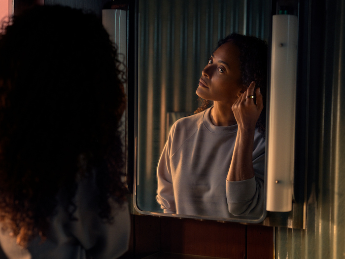 Woman looking in the mirror getting ready wearing Oura Ring