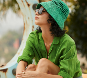 Woman wearing green hat and sunglasses | Oura Ring