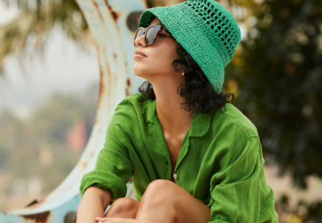Woman wearing green hat and sunglasses | Oura Ring