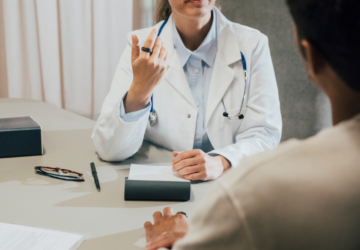 Doctor wearing white coat and Oura Ring