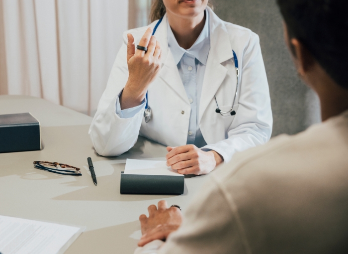 Doctor wearing white coat and Oura Ring