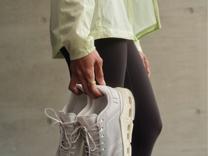 Person carrying sneakers wearing Oura Ring 5