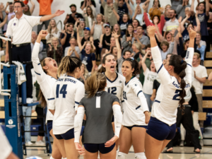 Utah State University's women's volleyball team celebrates a win. 