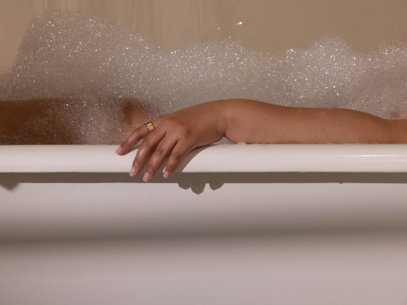 Woman taking a bath wearing Oura Ring