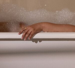 Woman taking a bath wearing Oura Ring