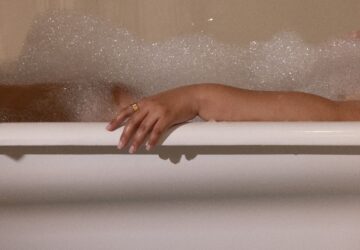 Woman taking a bath wearing Oura Ring
