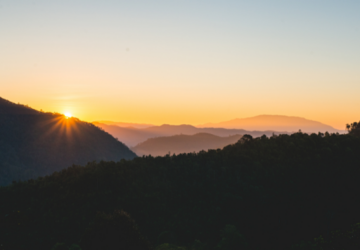 Sun setting over mountains