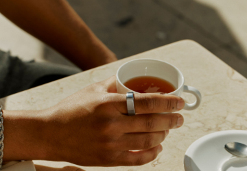 Person drinking tea wearing Oura Ring 4