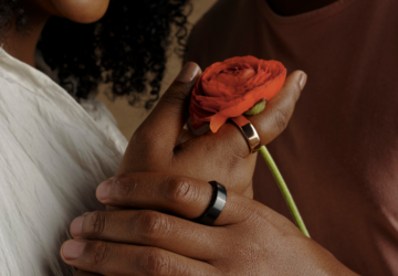 Two people wearing Oura Ring holding a rose