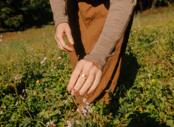 Person picking flowers wearing Oura Ring | How Allergies Impact Sleep