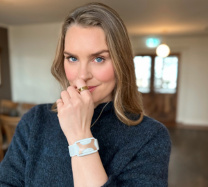 Actress, designer, former Olympic swimmer Ragga R. looks into the camera wearing Oura Ring and Apollo Neuro.