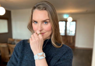 Actress, designer, former Olympic swimmer Ragga R. looks into the camera wearing Oura Ring and Apollo Neuro.