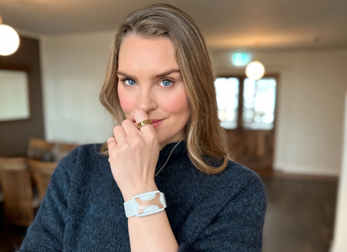 Actress, designer, former Olympic swimmer Ragga R. looks into the camera wearing Oura Ring and Apollo Neuro.