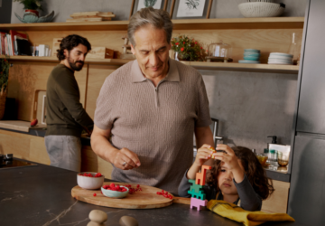 Man standing in kitchen with family | Oura Ring