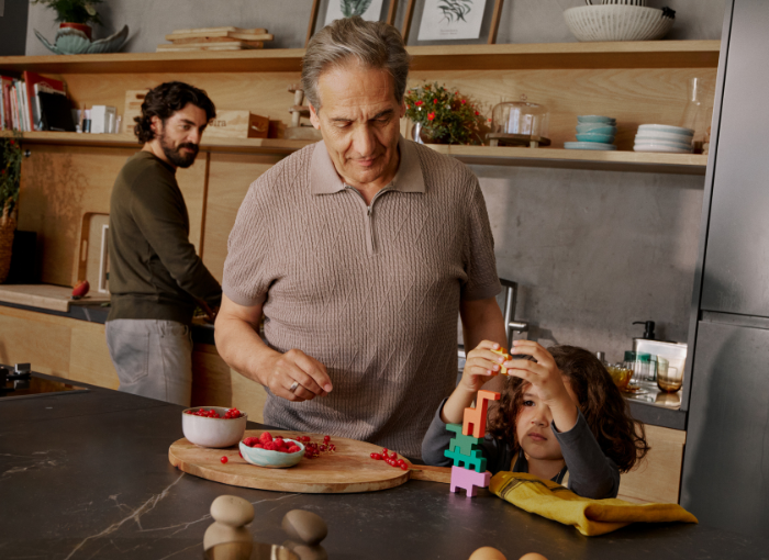 Man standing in kitchen with family | Oura Ring