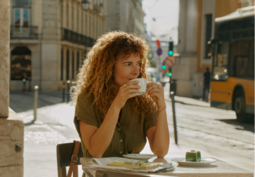 Woman wearing Oura Ring 4 drinking coffee