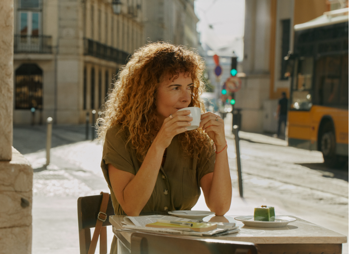 Woman wearing Oura Ring 4 drinking coffee