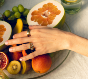 Person wearing Oura Ring reaching for fruit