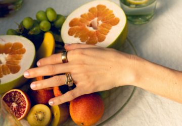 Person wearing Oura Ring reaching for fruit