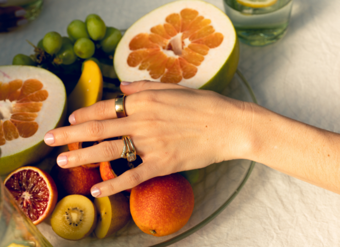 Person wearing Oura Ring reaching for fruit