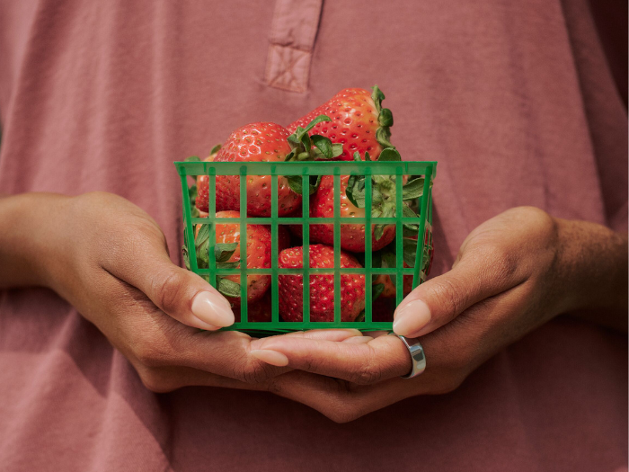 Person holding strawberries wearing Oura Ring 5