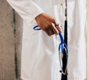 Doctor in white coat wearing Oura Ring