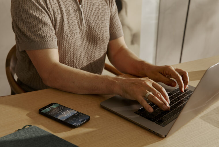 Man wearing Oura Ring and typing on computer