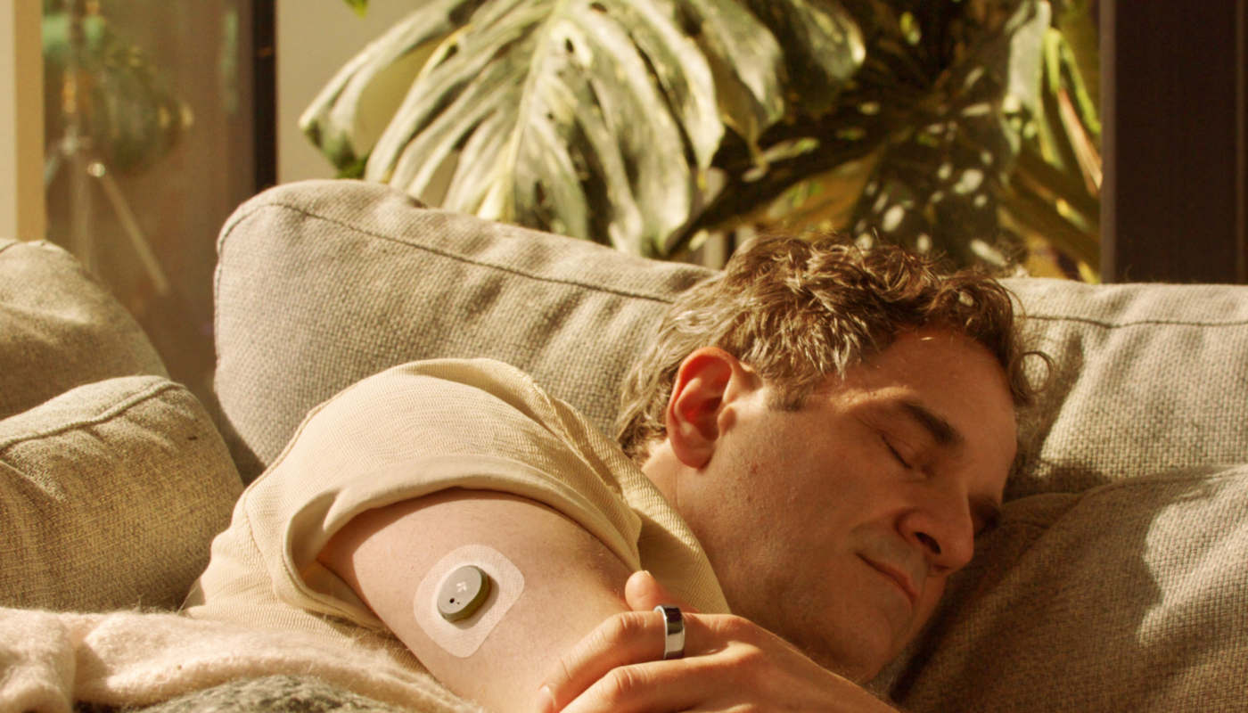 Man sleeping wearing Oura Ring + Stelo Glucose Biosensor