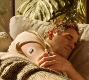 Man sleeping wearing Oura Ring + Stelo Glucose Biosensor