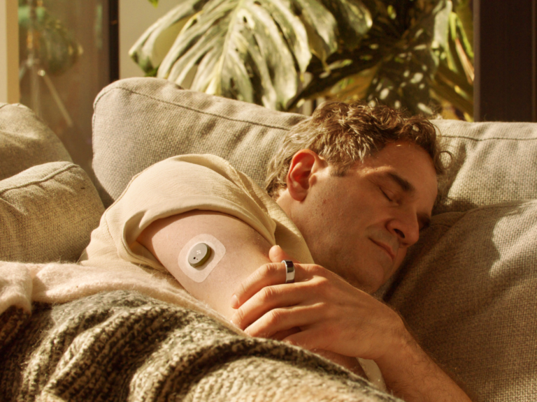 Man sleeping wearing Oura Ring + Stelo Glucose Biosensor