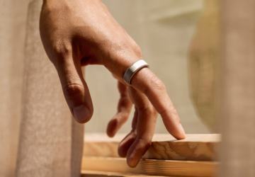 Person wearing Oura Ring standing by windowsill