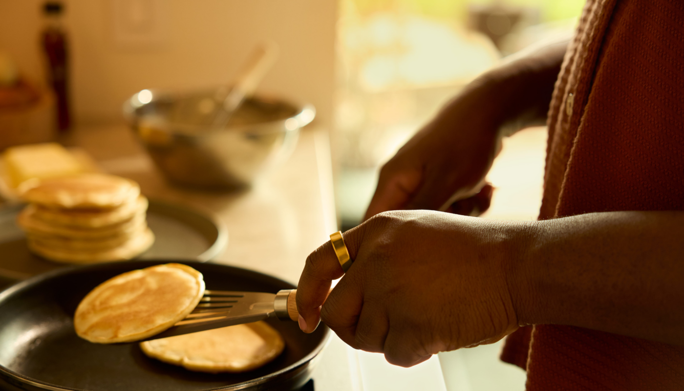 Person wearing Oura Ring making pancakes
