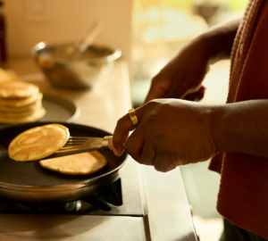Person wearing Oura Ring making pancakes