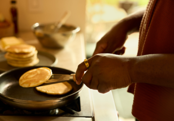 Person wearing Oura Ring making pancakes