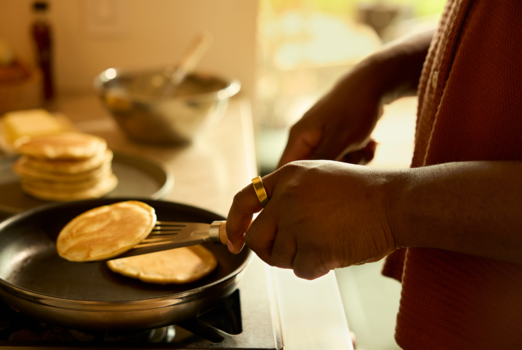 Person wearing Oura Ring making pancakes