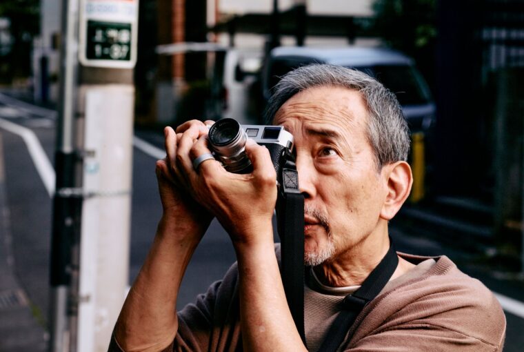 Man taking photograph wearing Oura Ring