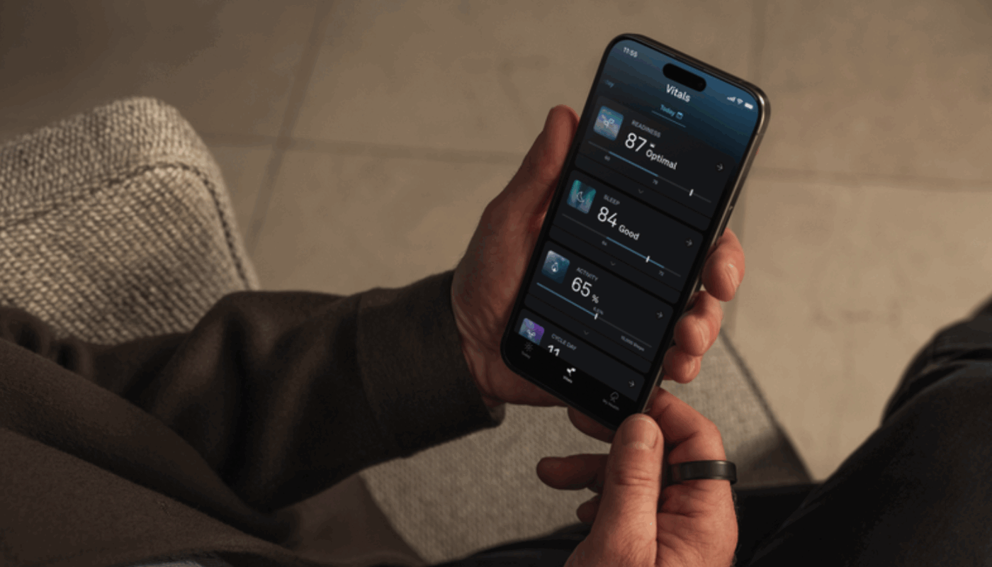 Oura member holding phone