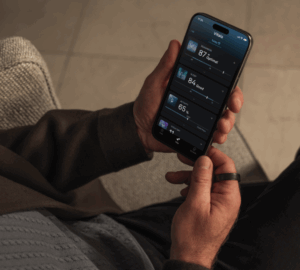 Oura member holding phone