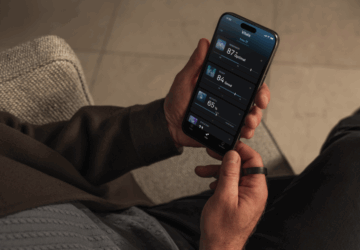 Oura member holding phone